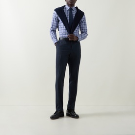 Model wearing Canali blue cotton check casual shirt, styled with navy knitwear vest, tailored trousers and black leather shoes.