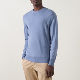 Model wearing Canali Fine-Knit Sweater in light blue crew neck wool knit, styled with beige trousers.