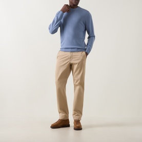 Model wearing Canali Light Blue Fine-Knit Crew Neck Sweater with beige chinos and brown suede shoes.