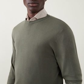 Model wearing Canali Fine-Knit Green Crew Neck Sweater in 100% wool, styled over a light pink shirt collar visible at neckline.