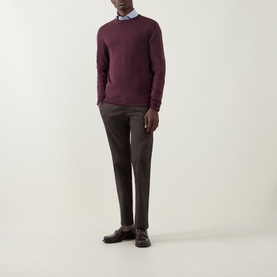 Model wearing Canali Fine-Knit Sweater in burgundy wool, crew neck, styled with grey trousers and a light blue shirt.