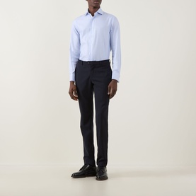 Model wearing Canali Textured Double-Cuff Shirt in blue with cutaway collar, styled with navy tailored trousers and black dress shoes.