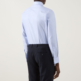 Model wearing Canali Textured Double-Cuff Shirt in blue, rear view showing double cuffs, curved hem, styled with navy trousers.