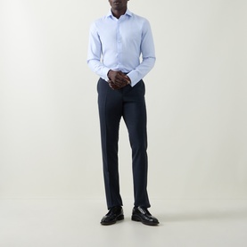 Model wearing Canali blue double cuff regular cotton formal shirt with navy tailored trousers and black leather loafers.