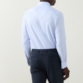 Model wearing Canali blue double cuff regular fit formal shirt, back view, styled with navy trousers