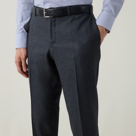 Model wearing Canali charcoal wool formal trousers with sharp front crease, styled with a blue check shirt and black leather belt