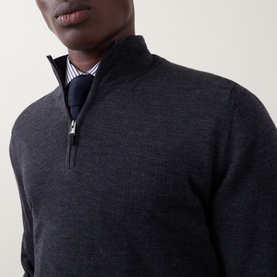 Model wearing Canali charcoal wool half-zip jumper, styled with a striped shirt and navy scarf, silver zip detail visible.
