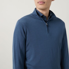 Model wearing Canali blue wool half-zip knit, styled over a collared shirt, close-up of chest and neckline detail.