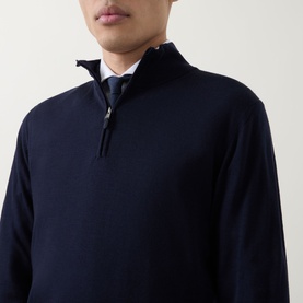 Model wearing Canali navy wool half-zip jumper, styled with a shirt and tie visible at collar.