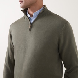 Model wearing Canali Merino Half-Zip Sweater in green, fine knit with zip collar, styled over a light blue shirt