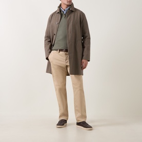 Model wearing Canali Green Merino Half-Zip Sweater with taupe mac coat, beige chinos and dark loafers.