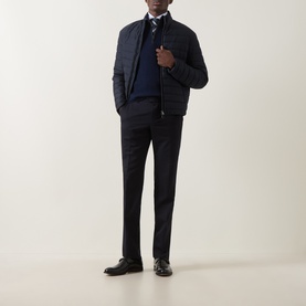Model wearing Canali navy wool-cashmere half zip, styled with a quilted bomber jacket, dress trousers, and black leather shoes.
