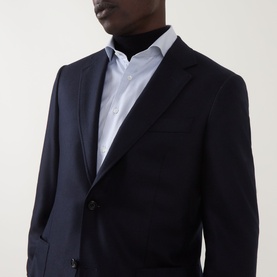 Model wearing Canali D6 Calvary Twill Suit Jacket in navy, single-breasted with notch lapel, styled with a white shirt and black rollneck.
