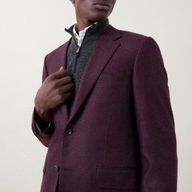 Model wearing Canali burgundy wool-silk blend jacket with notch lapels and two-button fastening, styled over a grey knit