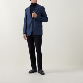 Model wearing Canali dark blue wool-silk blazer jacket, styled with black roll-neck and dark trousers with black leather loafers