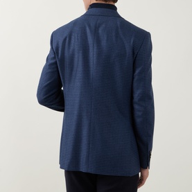 Model wearing Canali dark blue wool-silk blazer, shown from behind, paired with dark trousers