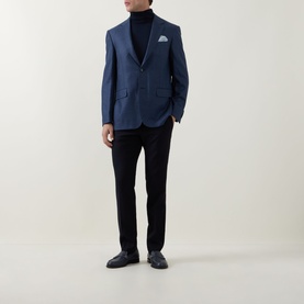 Model wearing Canali dark blue wool-silk blazer with pocket square, styled with black roll-neck, trousers and loafers