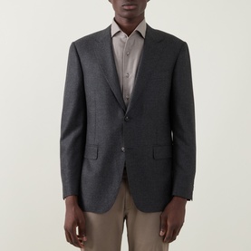 Model wearing Canali Prince Of Wales Check Suit Jacket in charcoal wool, single-breasted with notch lapel, styled with beige trousers and shirt