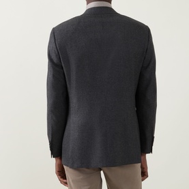 Model wearing Canali Prince Of Wales Check Suit Jacket in charcoal, rear view showing single-breasted cut, buttoned cuffs, and rear vents.