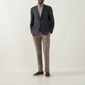 Model wearing Canali Prince Of Wales Check Suit Jacket in charcoal, styled with taupe trousers and dark loafers.