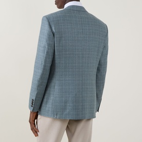 Model wearing Canali D6 Textured Single-Breasted Suit Jacket in mint check wool, rear view, styled with white shirt and stone trousers