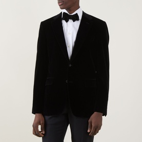 Model wearing Canali D6 Velvet Single-Breasted Suit Jacket in black, styled with white dress shirt and black bow tie.