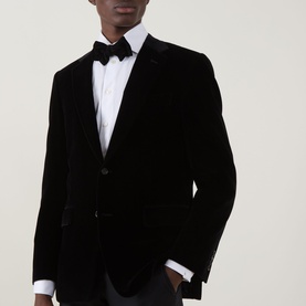 Model wearing Canali D6 Velvet Single-Breasted Suit Jacket in black, styled with white dress shirt and black bow tie