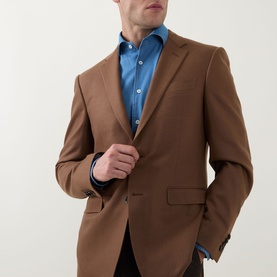 Model wearing Canali Flannel Single-Breasted Blazer in camel with notch lapel, styled with a blue shirt and dark trousers.