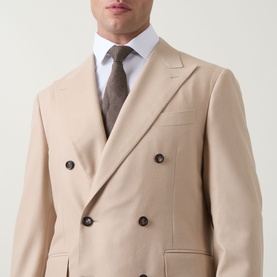 Model wearing Canali D8 Double-Breasted Blazer in navy, styled with white shirt and grey tie, peak lapels and button fastenings visible.