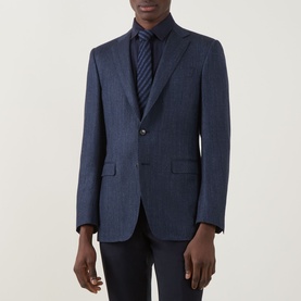 Model wearing Canali D8 Herringbone Single-Breasted Suit Jacket in Navy Nights, styled with a navy tie and dark trousers.