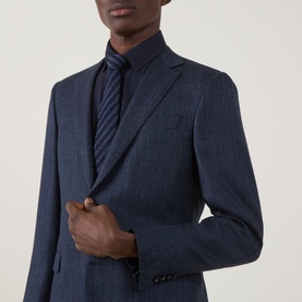 Model wearing Canali D8 Herringbone Single-Breasted Suit Jacket in Navy Nights, styled with a navy striped tie and matching shirt.