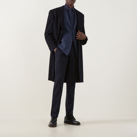 Model wearing Canali D8 Herringbone Single-Breasted Suit Jacket in Navy Nights, styled with a long navy overcoat and black dress shoes.