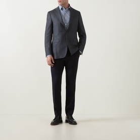 Model wearing Canali D8 Herringbone Single-Breasted Blazer in charcoal, styled with navy trousers, patterned shirt and black loafers.