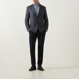 Model wearing Canali D8 Herringbone Single-Breasted Blazer in charcoal, styled with black trousers, printed shirt and dark leather shoes.
