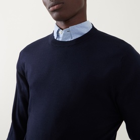 Model wearing Canali Fine-Knit Sweater in black, crew neck, styled over a light blue shirt collar visible at neckline.