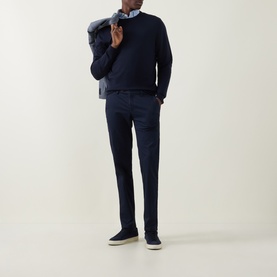 Model wearing Canali Fine-Knit Sweater in black, crew neck, 100% wool, styled with navy trousers and a light blue shirt.