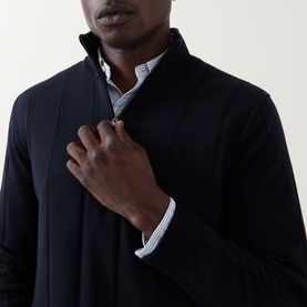 Model wearing Canali Textured Half-Zip Sweater in navy, showing funnel neck and half-zip detail, styled over a white shirt.