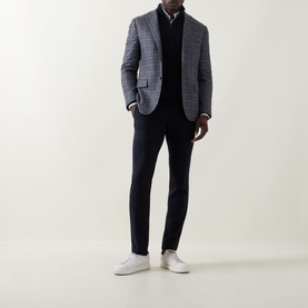 Model wearing Canali Textured Half-Zip Sweater in navy, styled with grey check blazer, black trousers and white trainers.