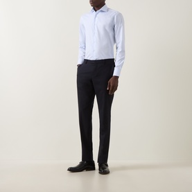 Model wearing Canali Light Blue Single Cuff Regular cotton formal shirt, styled with dark navy tailored trousers and black leather shoes.