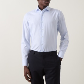 Model wearing Canali light blue cotton formal shirt with single cuff, styled with navy trousers