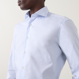 Model wearing Canali light blue cotton formal shirt with spread collar and single cuff regular fit, close-up chest detail