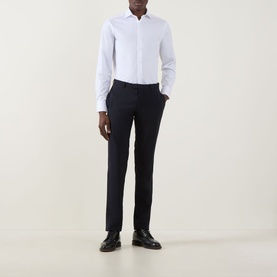 Model wearing Canali Pinpoint Single Cuff Shirt in white with pointed collar, styled with navy trousers and black leather shoes.
