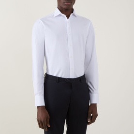 Model wearing Canali Pinpoint Single Cuff Shirt in white with pointed collar and single cuffs, styled with navy trousers.