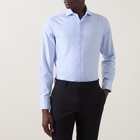 Model wearing Canali blue single cuff regular cotton formal shirt with spread collar, styled with navy tailored trousers.