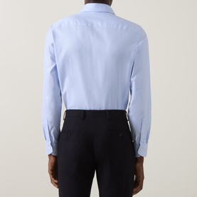 Model wearing Canali blue single cuff regular cotton formal shirt, rear view, styled with navy trousers.