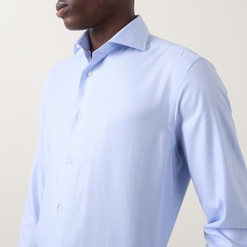 Model wearing Canali blue single cuff regular fit formal shirt in 100% cotton, featuring subtle texture and spread collar