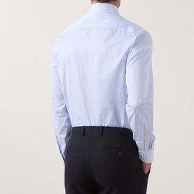 Model wearing Canali light blue cotton formal shirt, single cuff regular fit, styled with dark navy trousers. Rear view.
