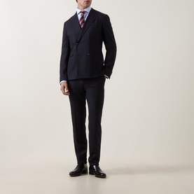 Model wearing Canali light blue single cuff regular cotton shirt, styled with navy double-breasted suit, striped tie, and black dress shoes.