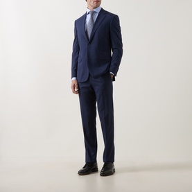 Model wearing Canali blue single cuff regular shirt, styled with a navy suit, grey tie, and black dress shoes.