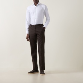 Model wearing Canali white cotton single cuff regular shirt with dark brown trousers and beige suede loafers.
